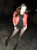 Sexy amateur teen wearing black pantyhose without panties lifts up her skirt outdoors